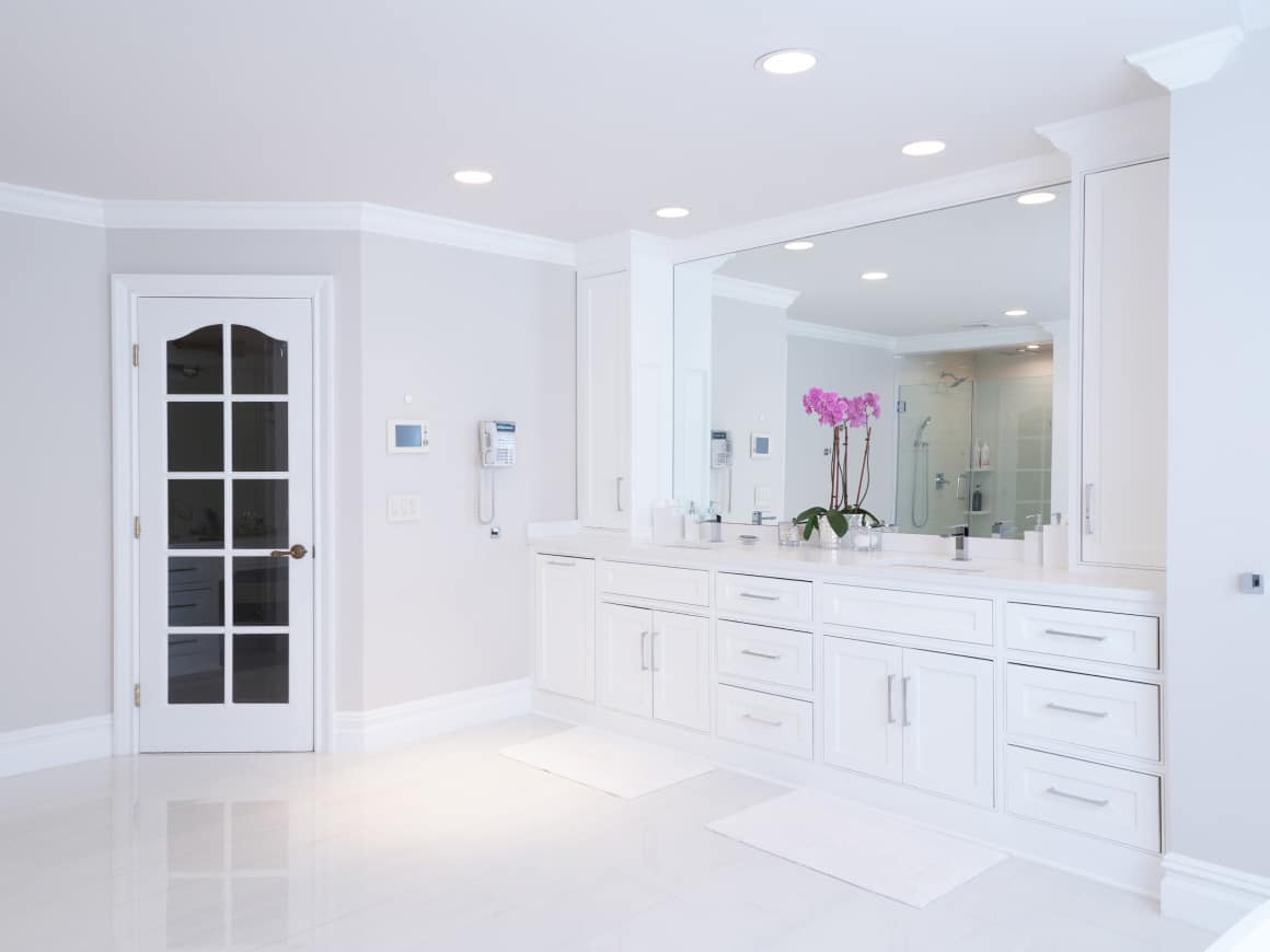 A Bathroom With A Large Mirror