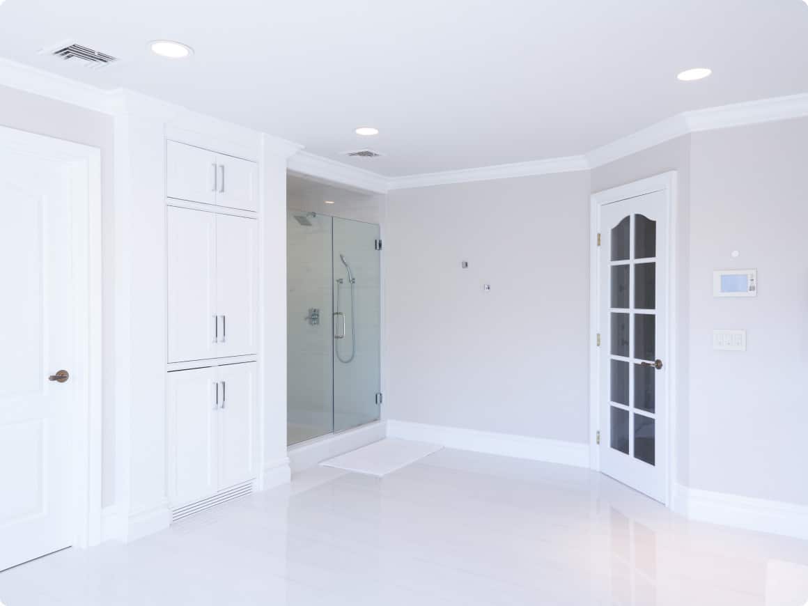 A White Bathroom With A Glass Shower