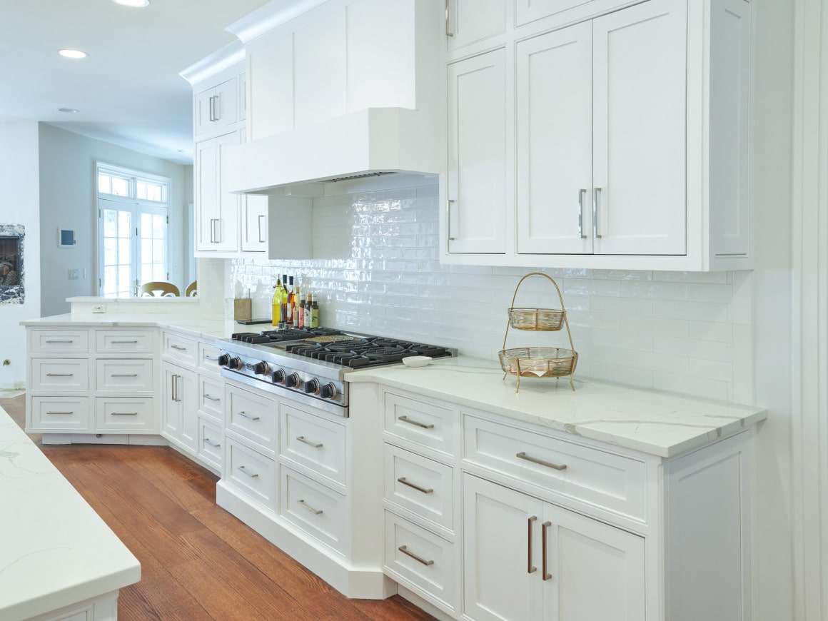A Kitchen With White Cabinets And White Appliances