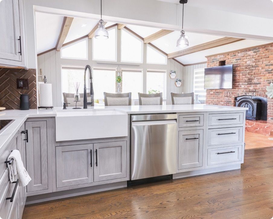 A Kitchen With White Cabinets And A Wood Floor